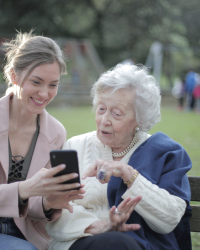 cheerful-senior-mother-and-adult-daughter-using-smartphone-low